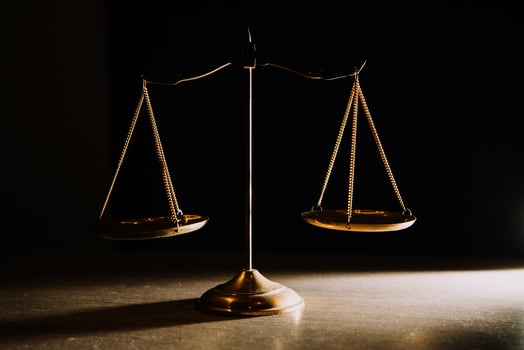 Business and lawyers discussing contract papers with brass scale on desk in office. Law, legal services, advice, justice and law concept picture with film grain effect photo