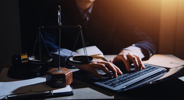 Business and lawyers discussing contract papers with brass scale on desk in office. Law, legal services, advice, justice and law concept picture with film grain effect photo