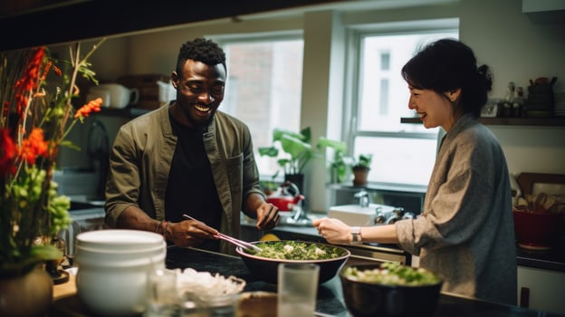 Black man and chinese woman cooking breakfast together. photo