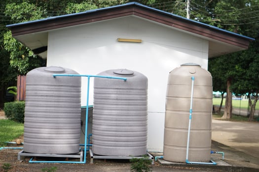 Big water tank installed outdoor for storage freshwater or rainwater to use in house or accommodation during summer or drought. Made of special grade material, extra thick, UV protection, no moss. photo