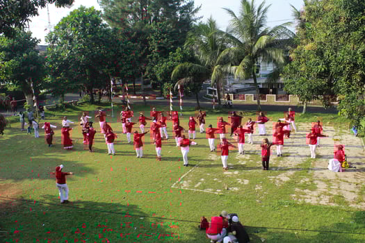 Bogor - Indonesia, August 17, 2023. photo of women doing gymnastics wearing red and white uniforms in a field in celebration of Indonesia's Independence Day on August 17.