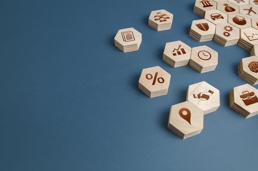 Wooden figurines with business attributes. Components for building a successful company and career growth. Management. Improving the investment climate, attracting investors. Business education. photo