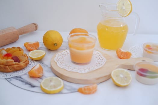 Fresh orange juice in a glass with fresh fruits on a white background photo