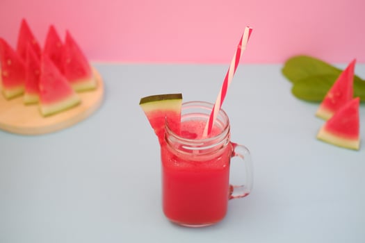 Watermelon smoothie in a glass jar with straws as a background photo