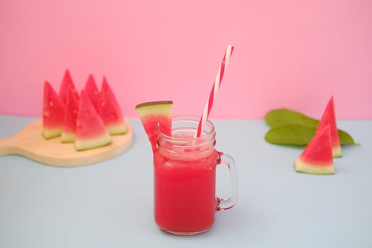 Watermelon smoothie in a glass jar with straws as a background photo