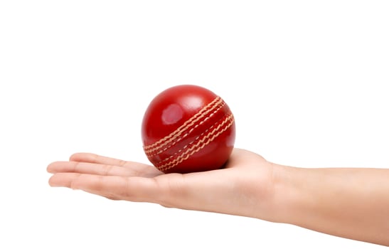 Shiny Red Test Match Leather Stitch Cricket Ball In Women Hand Closeup Photo White Background