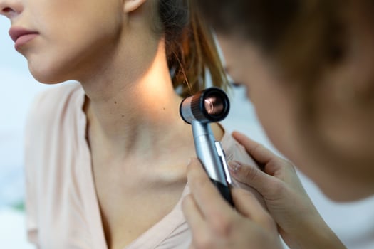 Doctor dermatologist examines skin of patient. Dermatoscopy, prevention of melanoma, skin cancer. photo