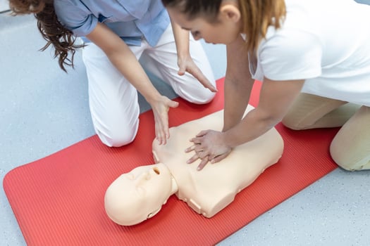 Demonstrating CPR Cardiopulmonary resuscitation  training medical procedure on CPR doll in the class.Doctor and nurse students are learning how to rescue the patient.First aid for safe life concept. photo
