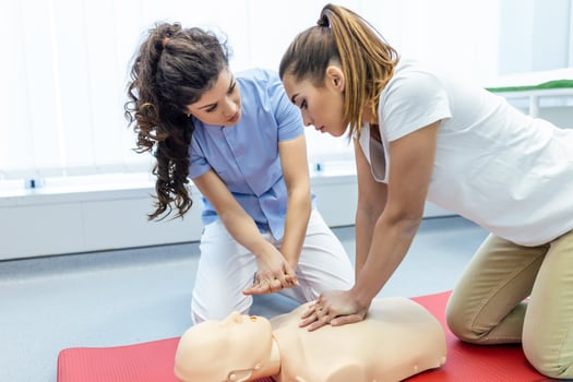 Demonstrating CPR Cardiopulmonary resuscitation  training medical procedure on CPR doll in the class.Doctor and nurse students are learning how to rescue the patient.First aid for safe life concept. photo