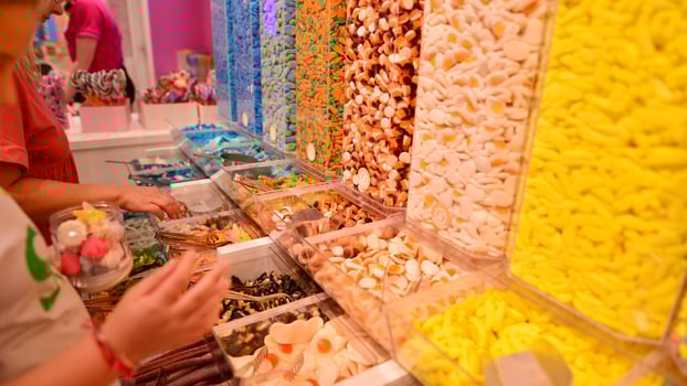 Plastic jars filled with colourful candy in shop. photo