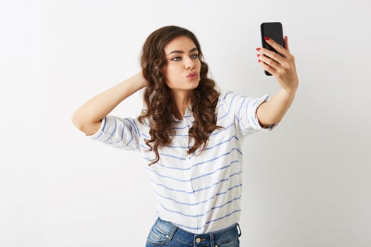 beautiful woman making selfie photo on mobile phone, smiling, islolated, winking,