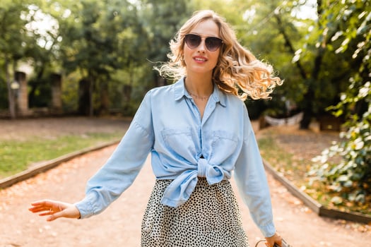 stylish blond woman walking in street park summer fashion photo