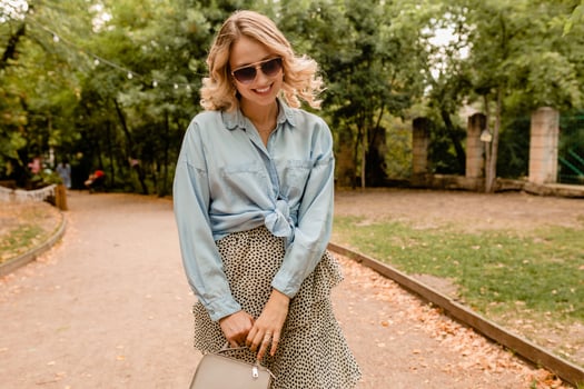 stylish blond woman walking in street park summer fashion photo