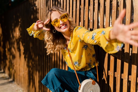 attractive blond stylish smiling woman in yellow blouse photo
