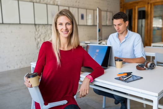 young man and woman working on laptop in open space co-working office room, busy freelancers photo