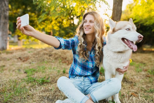 woman taking selfie photo with dog
