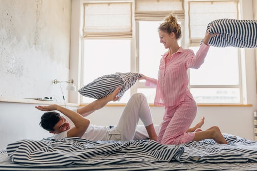 young couple having fun on bed in morning photo