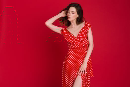 stylish woman in summer fashion trend dress on red background photo