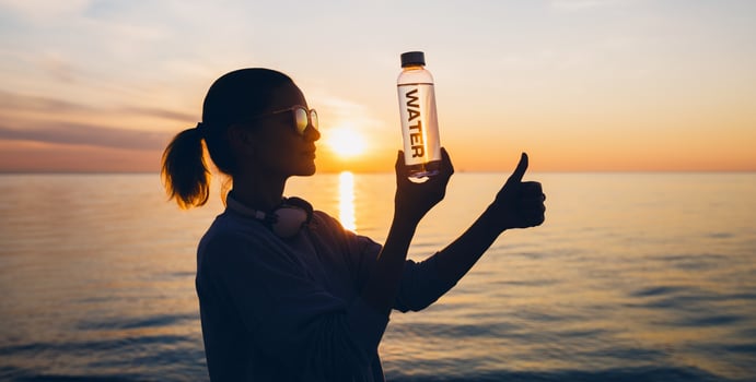 woman at sea holding bottle of water photo