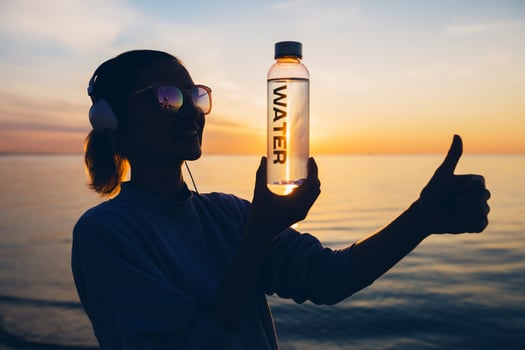 woman at sea holding bottle of water photo