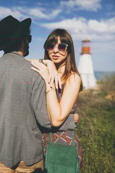 young hipster couple indie style in love walking in countryside, lighthouse on background photo