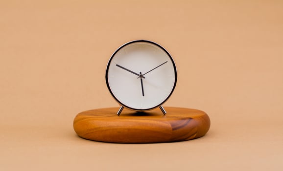 Modern alarm clock placed on a wooden plan Time clock, notifications, alarms time and work concept photo