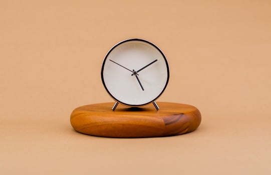 Modern alarm clock placed on a wooden plan Time clock, notifications, alarms time and work concept photo