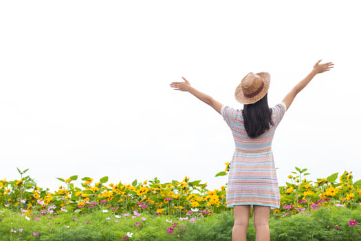 young woman blessed the view of flower garden that looks beautiful in summer alone. Young woman tourists admiring beauty of summer scenery and beautiful flower gardens Copy Space for text photo