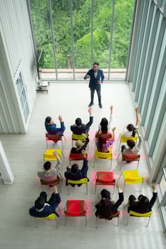 Top view of a group of business people sitting and listening to a presentation in a conference hall photo
