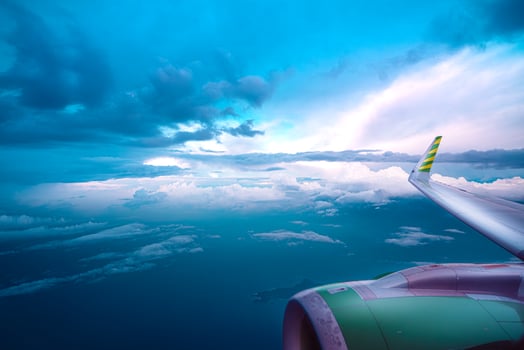 View from the airplane window on a beautiful sunset above the clouds. photo