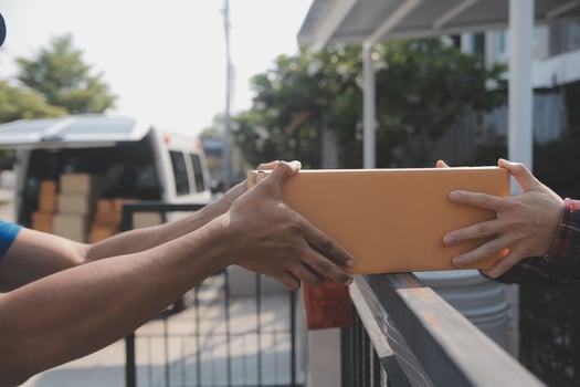 Young woman small business owner online shopping at home. taking note of orders from customers with mobile phones. SME entrepreneur or freelance life style concept. photo