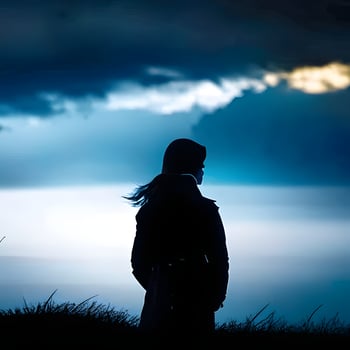 Silhouette of a lonely woman stands alone photo