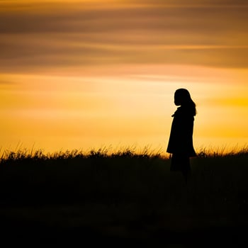 Silhouette of a lonely woman stands alone photo
