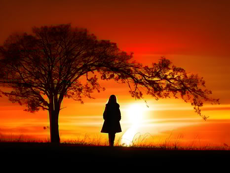 Silhouette of a lonely woman stands alone photo