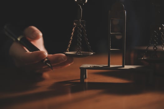 Business and lawyers discussing contract papers with brass scale on desk in office. Law, legal services, advice, justice and law concept picture with film grain effect photo