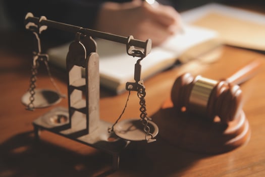 Business and lawyers discussing contract papers with brass scale on desk in office. Law, legal services, advice, justice and law concept picture with film grain effect photo