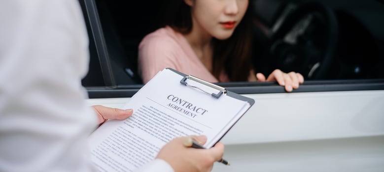 Automotive business, car sale or rental concept Customer with car dealer agent making deal and signing on agreement document contract in auto showroom or on road photo