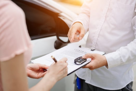 Automotive business, car sale or rental concept Customer with car dealer agent making deal and signing on agreement document contract in auto showroom or on road photo