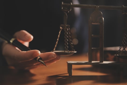 Business and lawyers discussing contract papers with brass scale on desk in office. Law, legal services, advice, justice and law concept picture with film grain effect photo