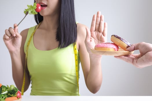 slim body Women choose during healthy foods and donut, female choose salad for diet. Good healthy food. weight lose, balance, control, reduce fat, low calories, routines, exercise. photo