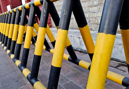 The car barrier on the road to the private office area. Iron yellow-black blocking the road to road transport barrier. Barrier of private property photo