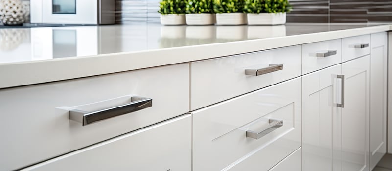 Closeup of white kitchen counters with drawers photo