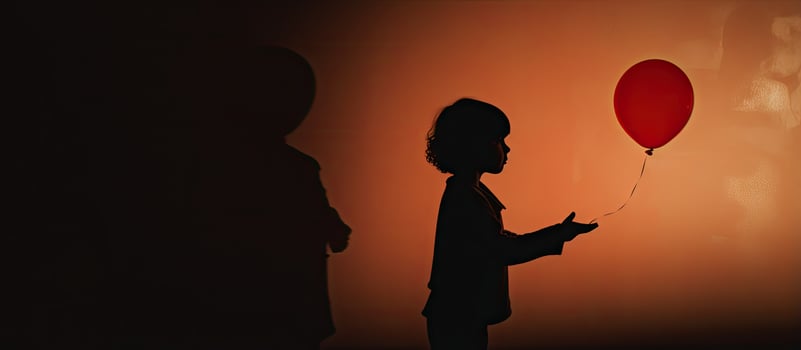Child s shadow clutching a balloon photo
