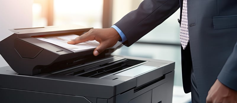 Office workers utilize a panel to operate a printer or photocopier for scanning and printing documents photo