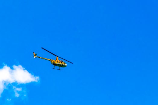 Tourist helicopter flies over the Caribbean Sea in Mexico. photo