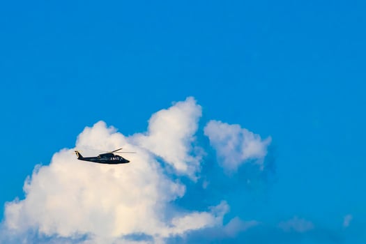 Tourist helicopter flies over the Caribbean Sea in Mexico. photo