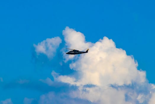 Tourist helicopter flies over the Caribbean Sea in Mexico. photo