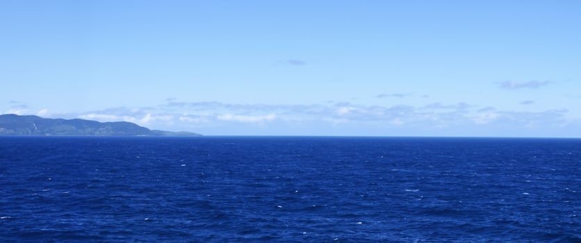 High angle view of coastline and hills calm sea photo