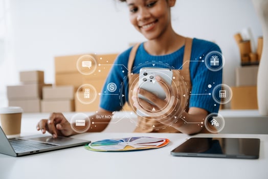 Young woman holding a smartphone, tablet showing payment success and credit card with yellow parcel box as online shopping concept photo