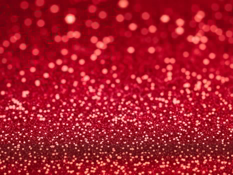 Red christmas glitter background with stars. Festive glowing blurred texture. photo